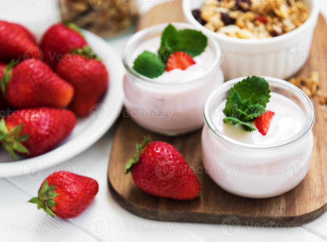 healthy breakfast, yogurt, fresh strawberries and granola photo