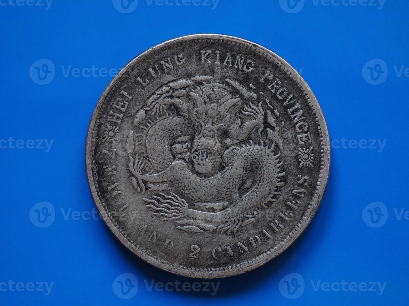 Old chinese coin over blue photo