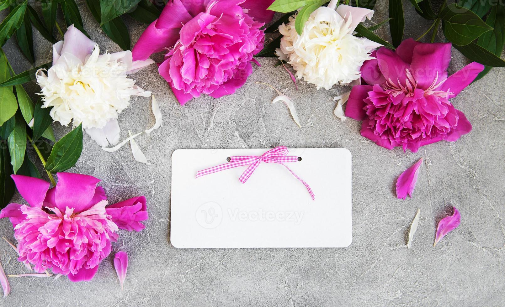 invitation card and pink peony flowers photo