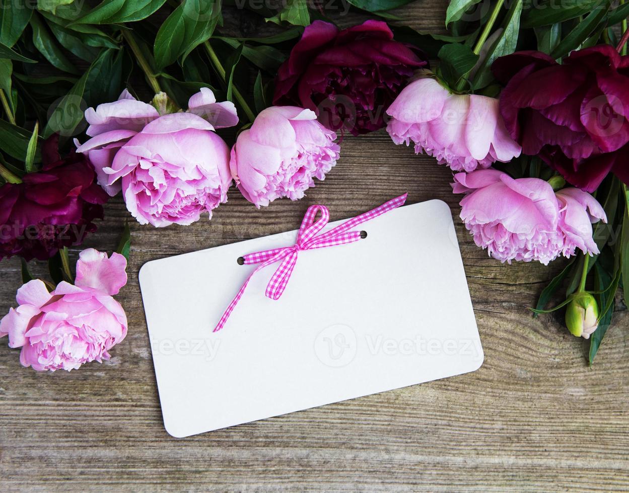 invitation card and pink peony flowers photo