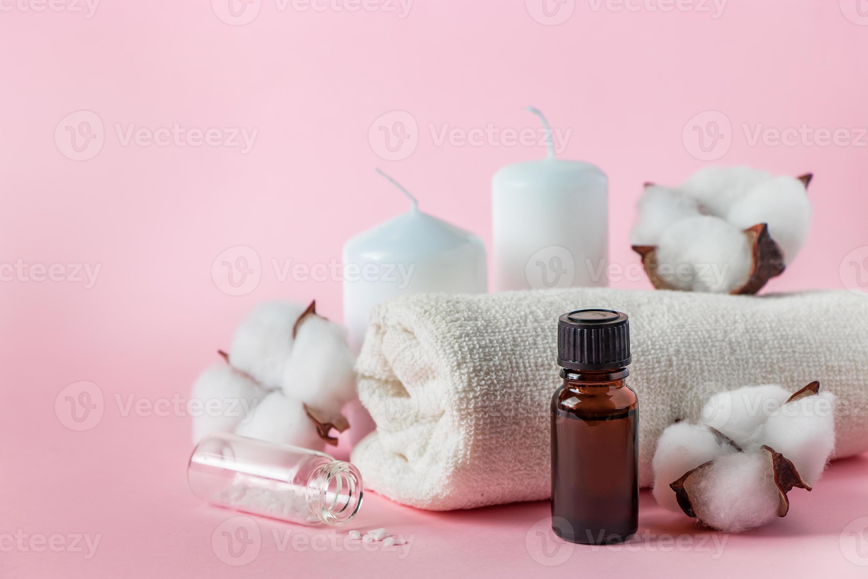 Natural cosmetic products for spa and aromatherapy. Relaxation concept.  Candles, flowers and a towel on a pink background. 5464425 Stock Photo at  Vecteezy