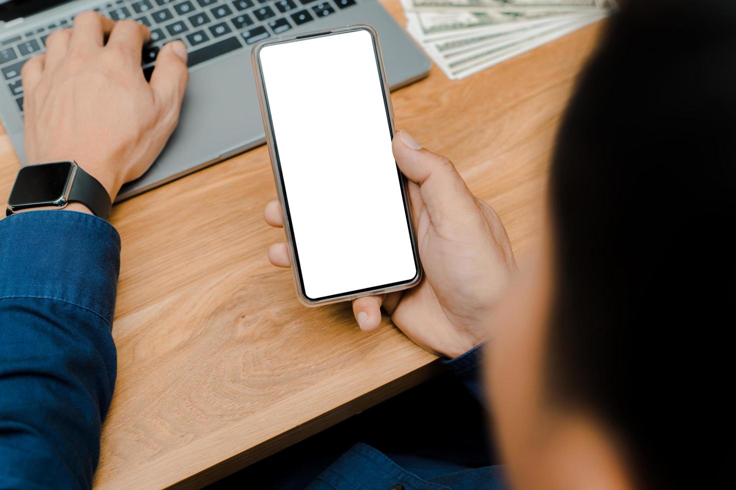 Blank mockup, white screen, mobile phone.men holding text messages using mobile relaxing on sofa at home. empty space background for ads marketing business photo