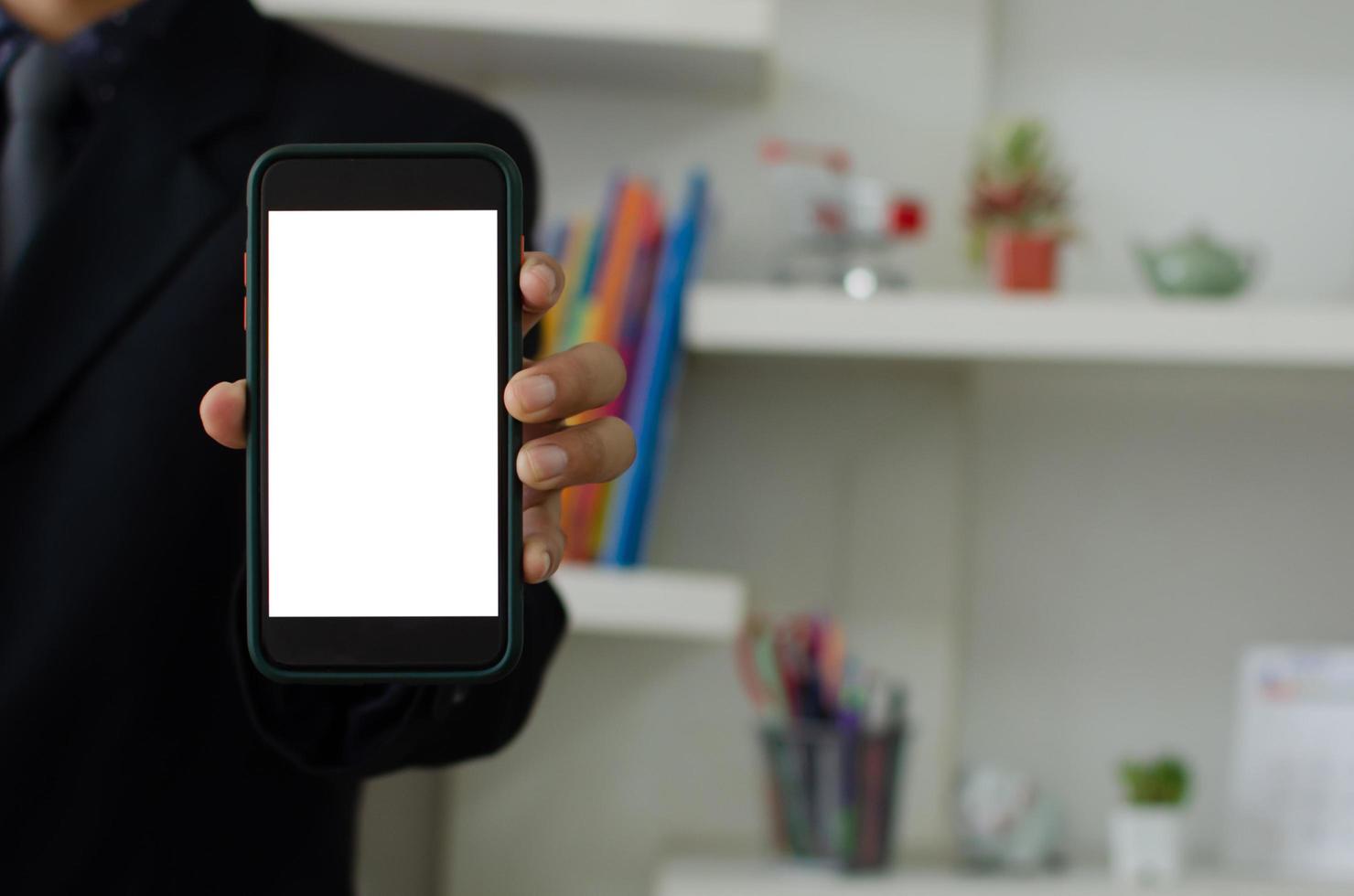 Mockup a mobile phone in the man hand. Blank screen with text or image for an advertisement. photo