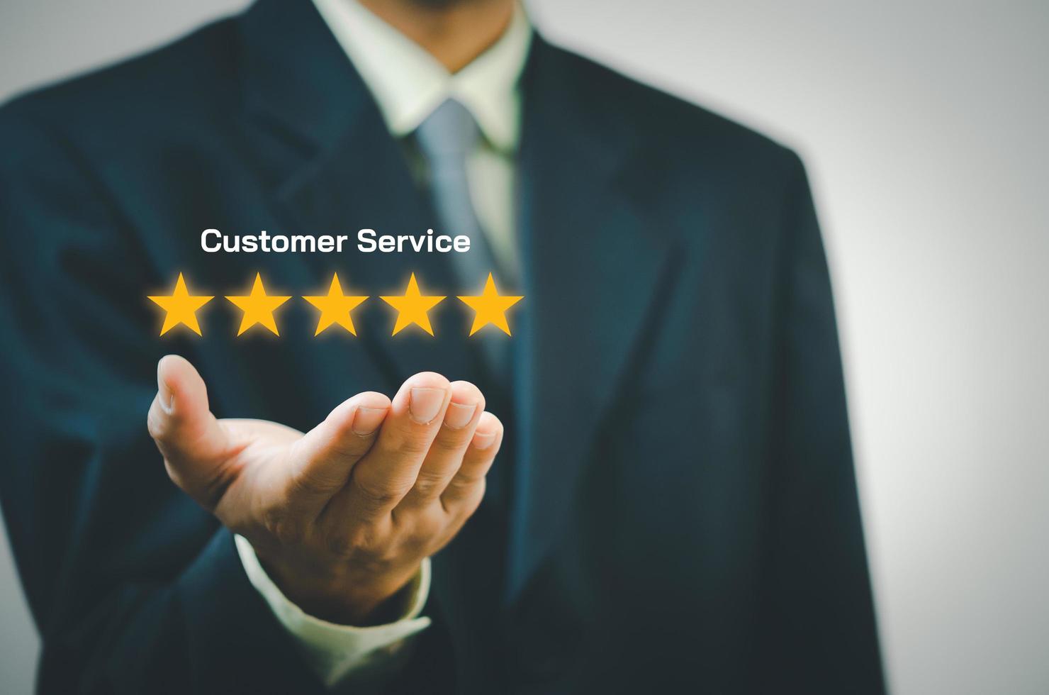 Businessman holding 5 stars on hands.Customer satisfaction and marketing survey rating concept photo