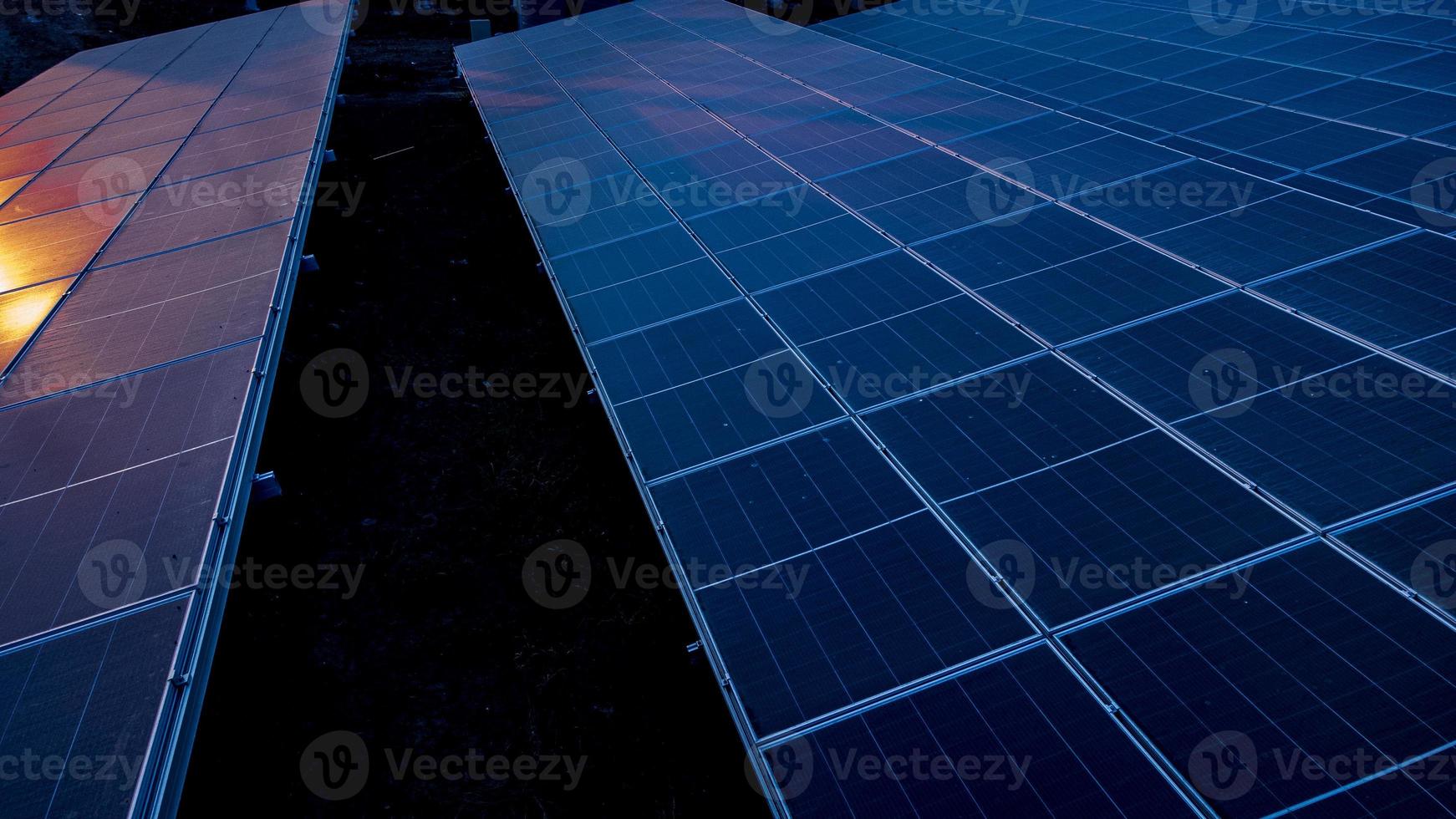 Top view of solar panels solar cell in solar farm and sun lighting reflect with copy space. Photovoltaic power plant field for power generation. Concept of global warming and climate change. photo