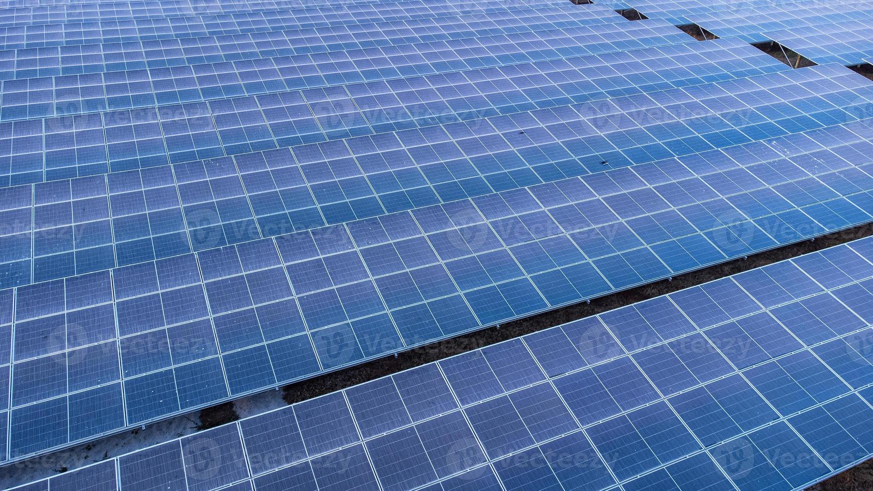 Top view of solar panels solar cell in solar farm and sun lighting reflect with copy space. Photovoltaic power plant field for power generation. Concept of global warming and climate change. photo