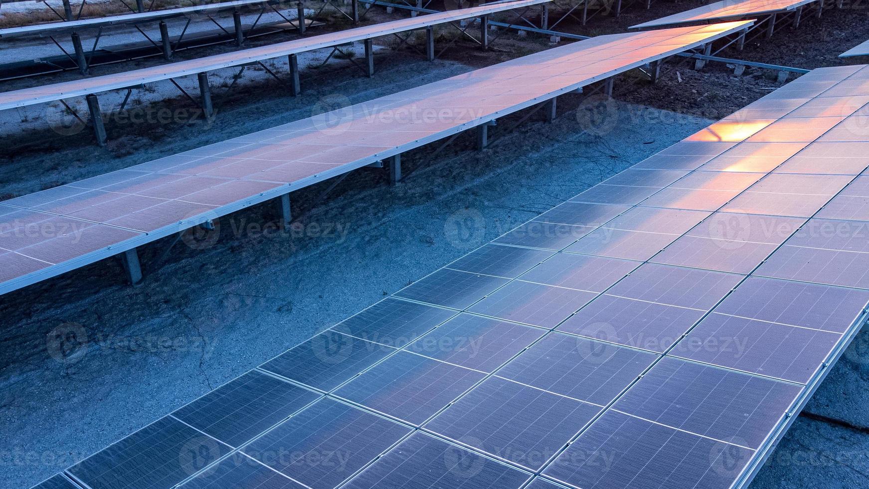 Top view of solar panels solar cell in solar farm and sun lighting reflect with copy space. Photovoltaic power plant field for power generation. Concept of global warming and climate change. photo