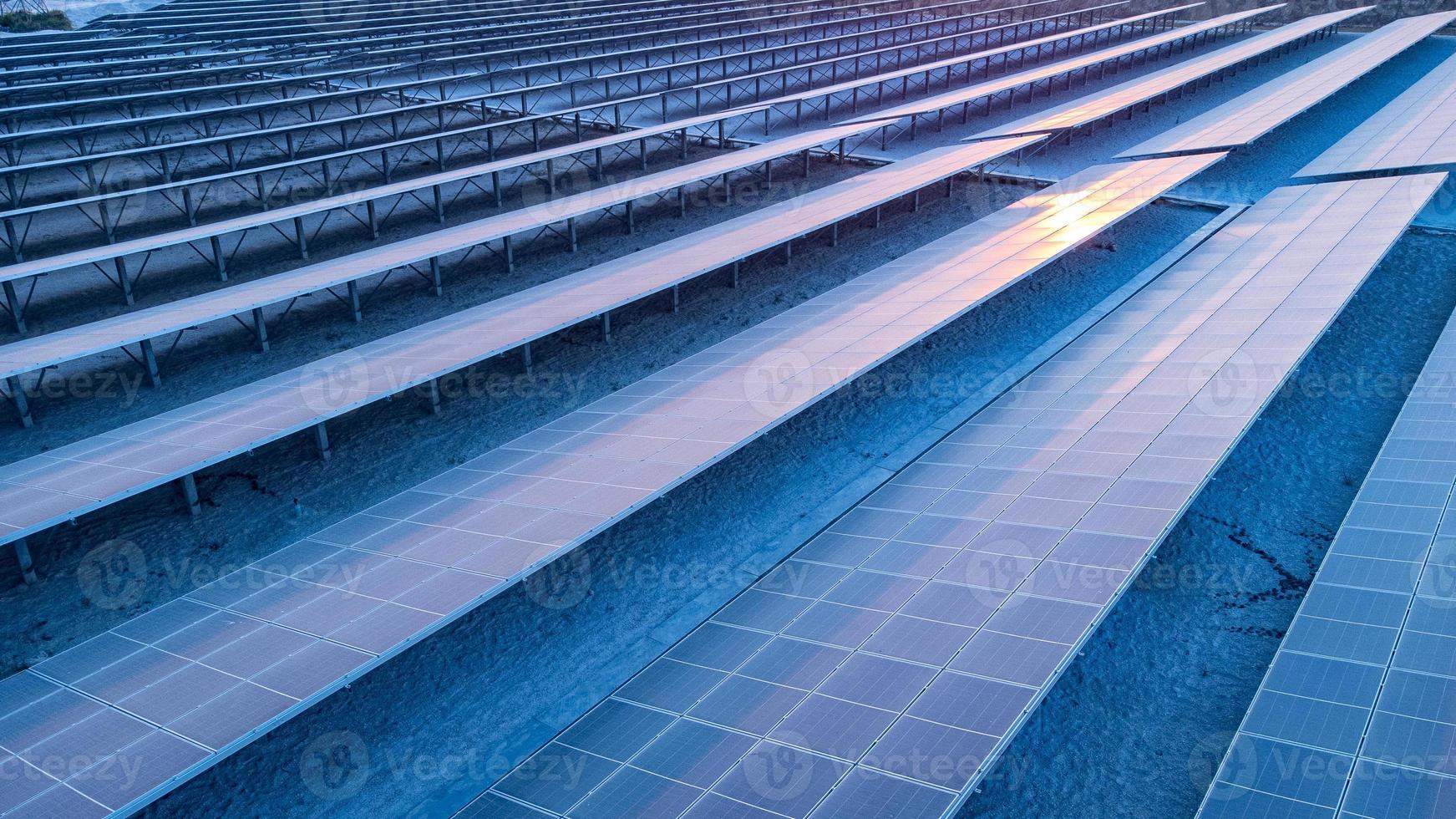 Top view of solar panels solar cell in solar farm and sun lighting reflect with copy space. Photovoltaic power plant field for power generation. Concept of global warming and climate change. photo