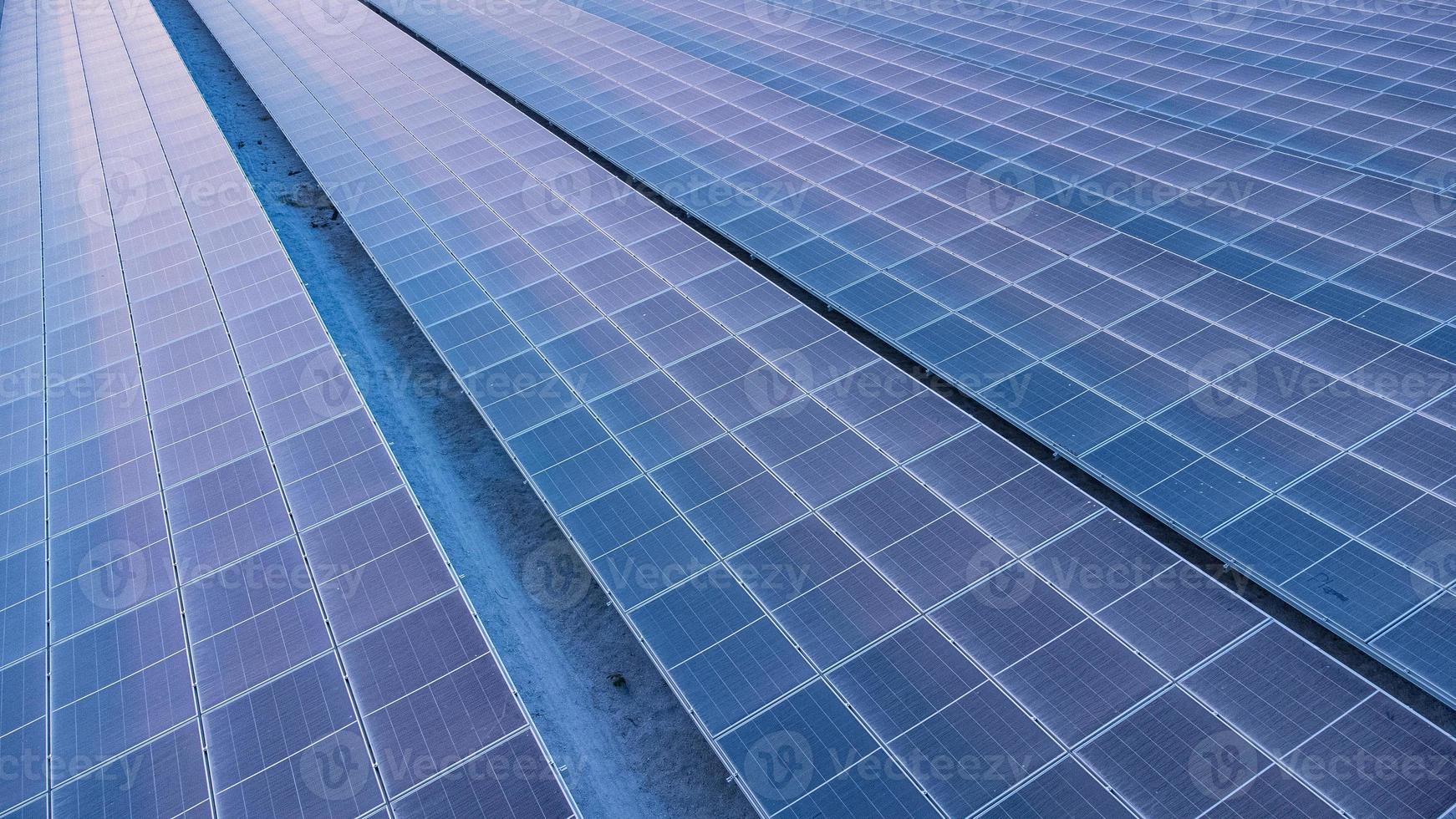 Top view of solar panels solar cell in solar farm and sun lighting reflect with copy space. Photovoltaic power plant field for power generation. Concept of global warming and climate change. photo