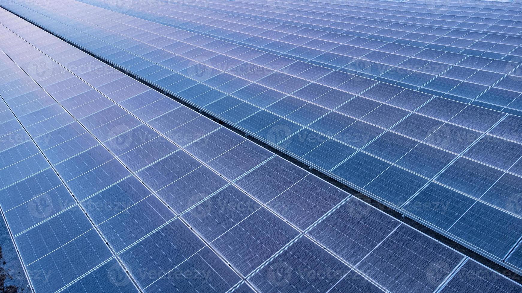 Top view of solar panels solar cell in solar farm and sun lighting reflect with copy space. Photovoltaic power plant field for power generation. Concept of global warming and climate change. photo