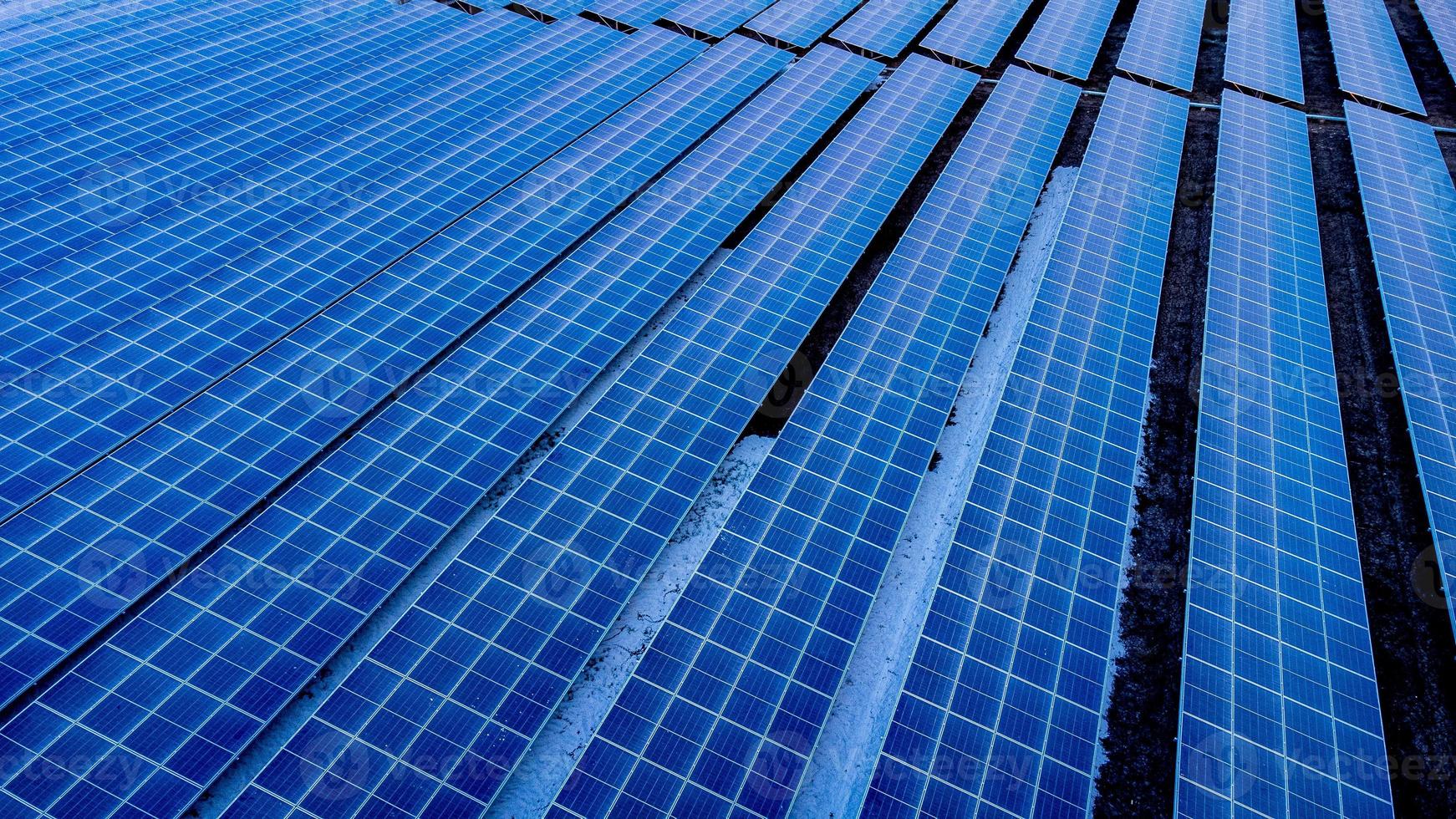 Top view of solar panels solar cell in solar farm and sun lighting reflect with copy space. Photovoltaic power plant field for power generation. Concept of global warming and climate change. photo