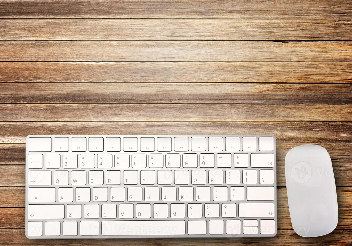 Top view with mini wireless keyboard and mouse on brown wood table