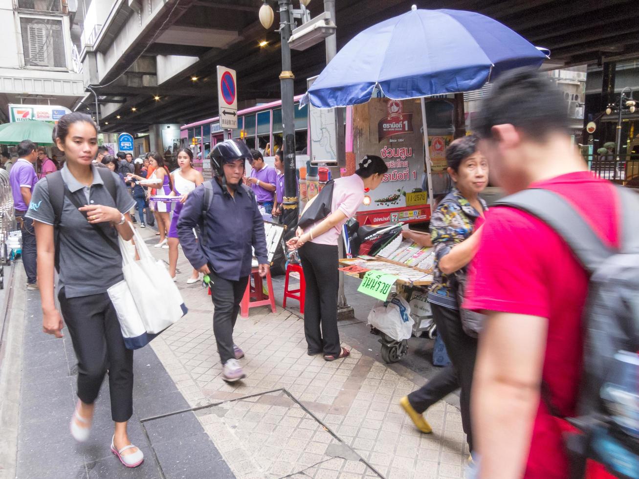 Silom BANGKOKTHAILAND16 AUGUST 2018  In the morning people are walking to work and doing activities such as buying coffee to buy or shopping for lottery tickets and queuing for a motorcycle. photo