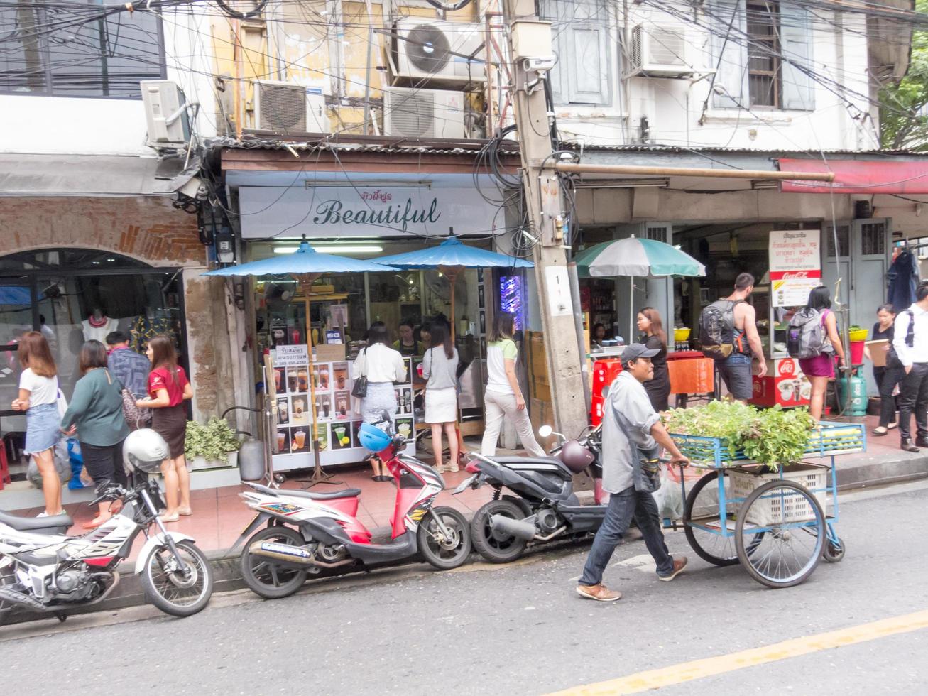 Silom BANGKOKTHAILAND16 AUGUST 2018  In the morning people are walking to work and doing activities such as buying coffee to buy or shopping for lottery tickets and queuing for a motorcycle. photo