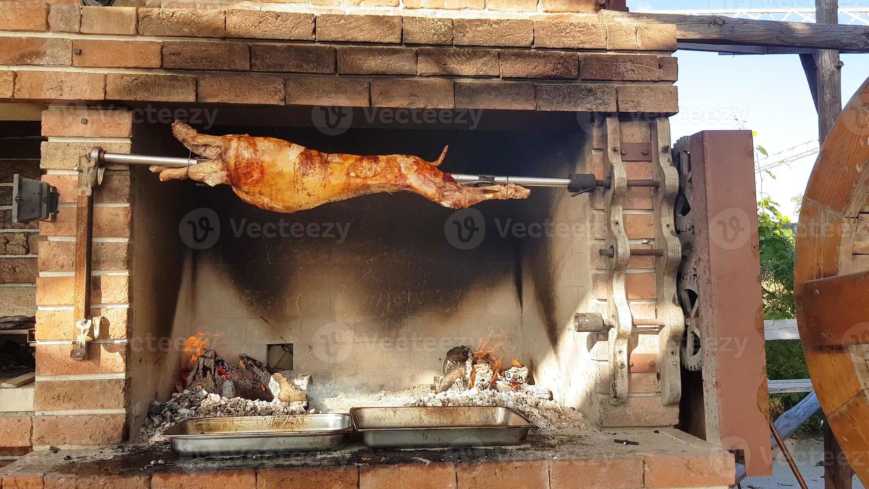 Spit Roasted Lambs, traditional way of roasting lambs on a rotisserie spit in Bulgaria. Cheverme.. photo