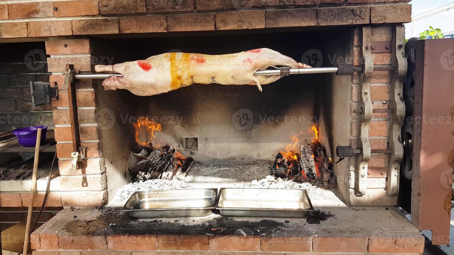 Spit Roasted Lambs, traditional way of roasting lambs on a rotisserie spit in Bulgaria. Cheverme.. photo