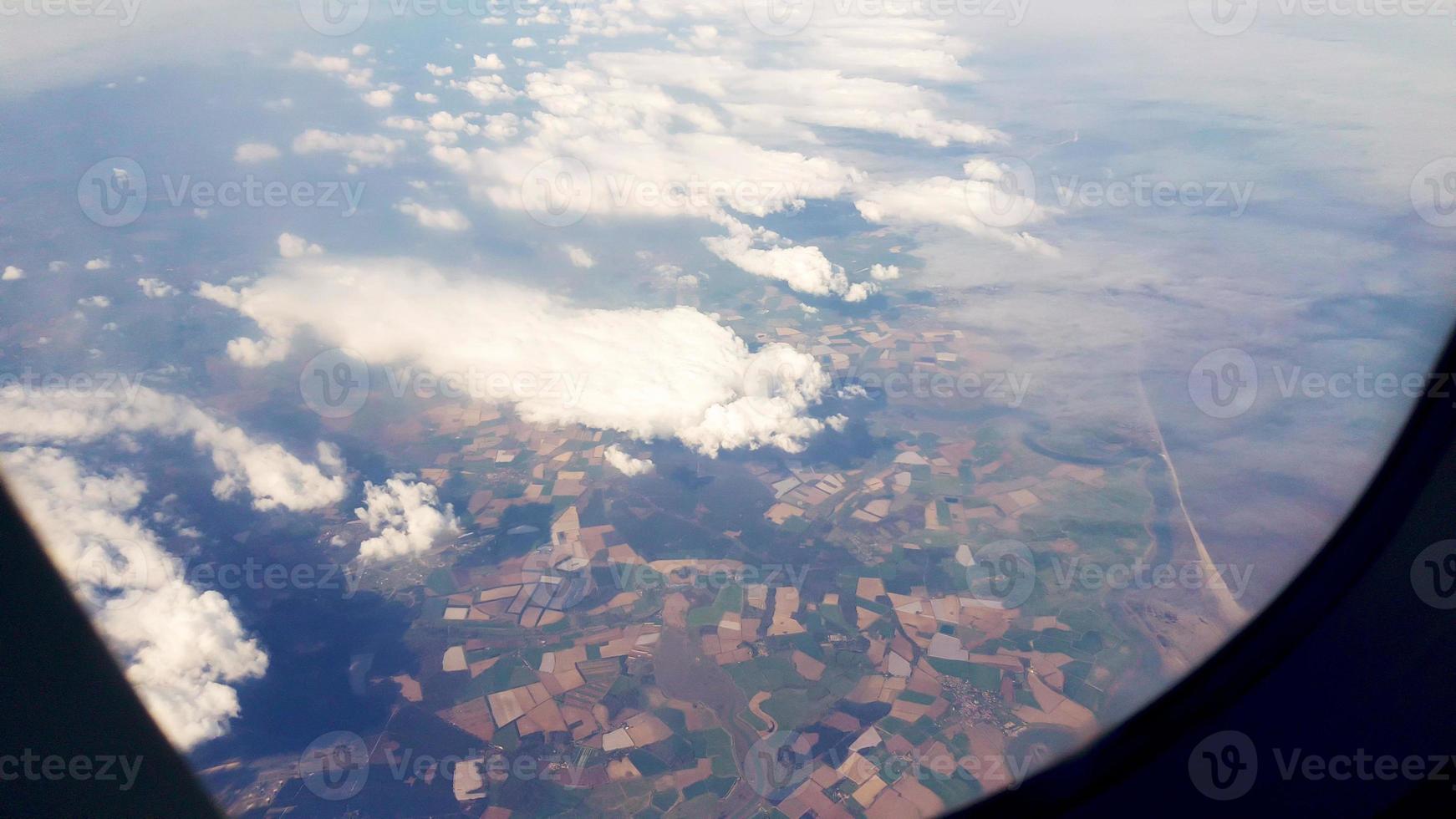 Aerial footage from the window on a airplane above very low clouds. photo
