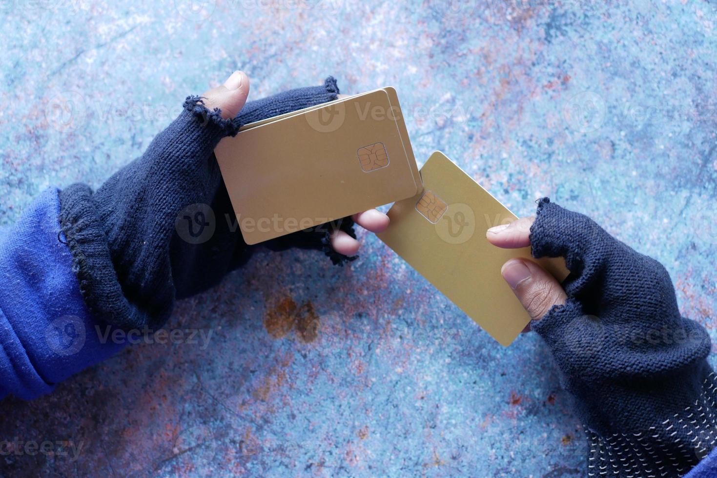 hacker hand stealing data from credit card photo
