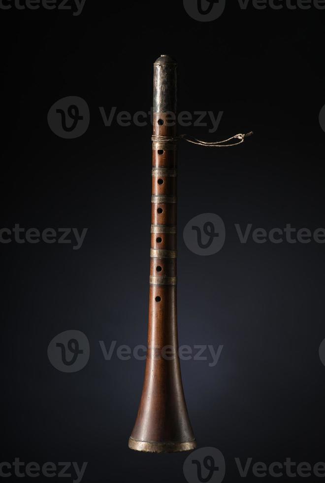 ancient asian woodwind musical instrument on a black background, surnay photo