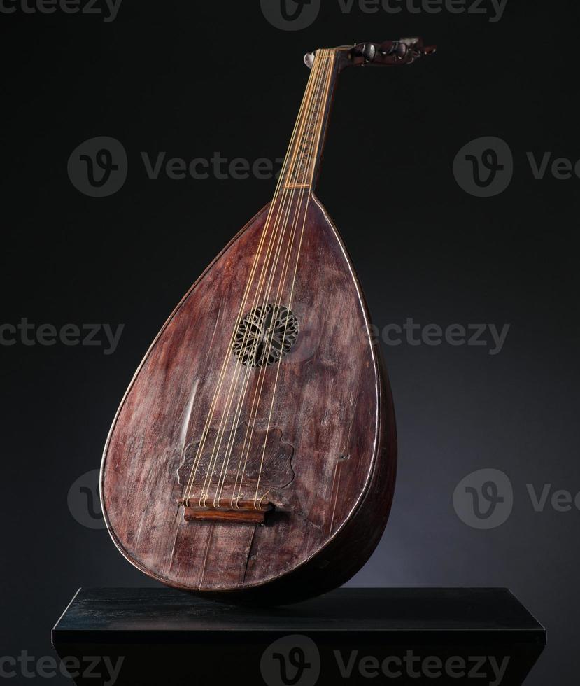 ancient Asian stringed musical instrument on black background with backlight photo