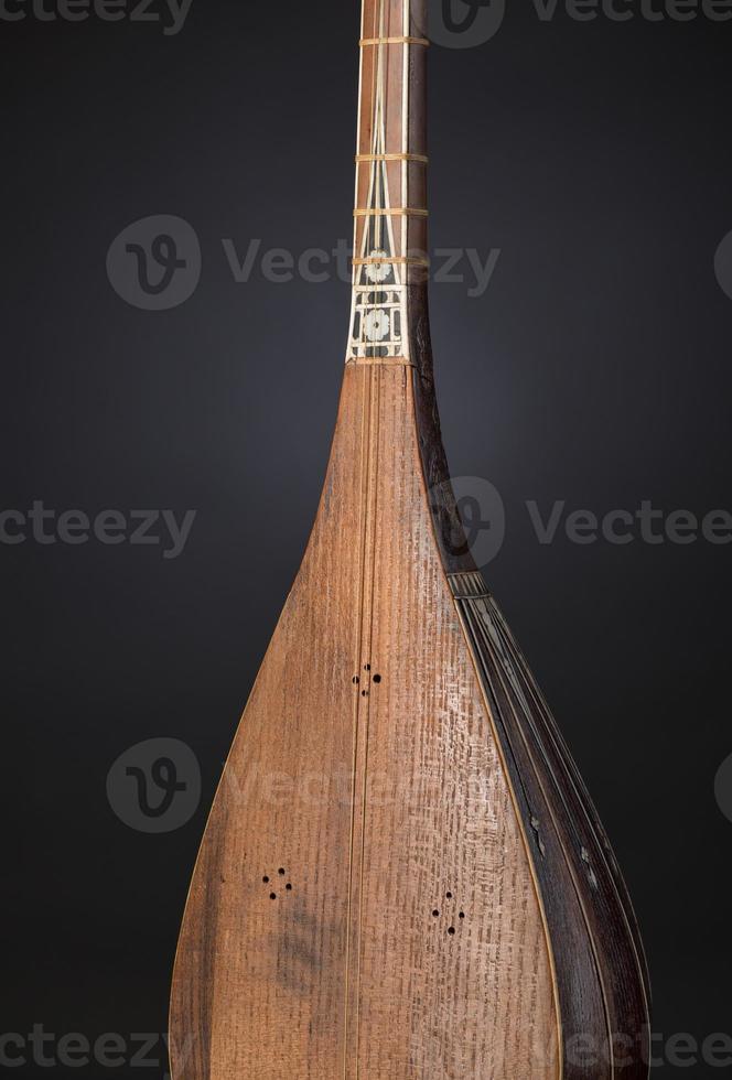 part ancient Asian stringed musical instrument on black background with backlight photo