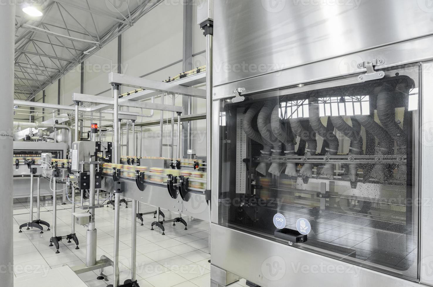 conveyor belt in motion at production and bottling of drinks in tin cans. production and bottling of drinks in tin cans photo