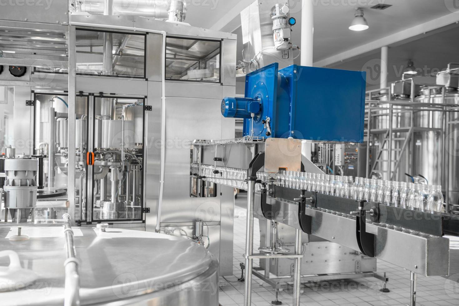 empty plastic bottles on conveyor belt. equipment at the dairy plant photo