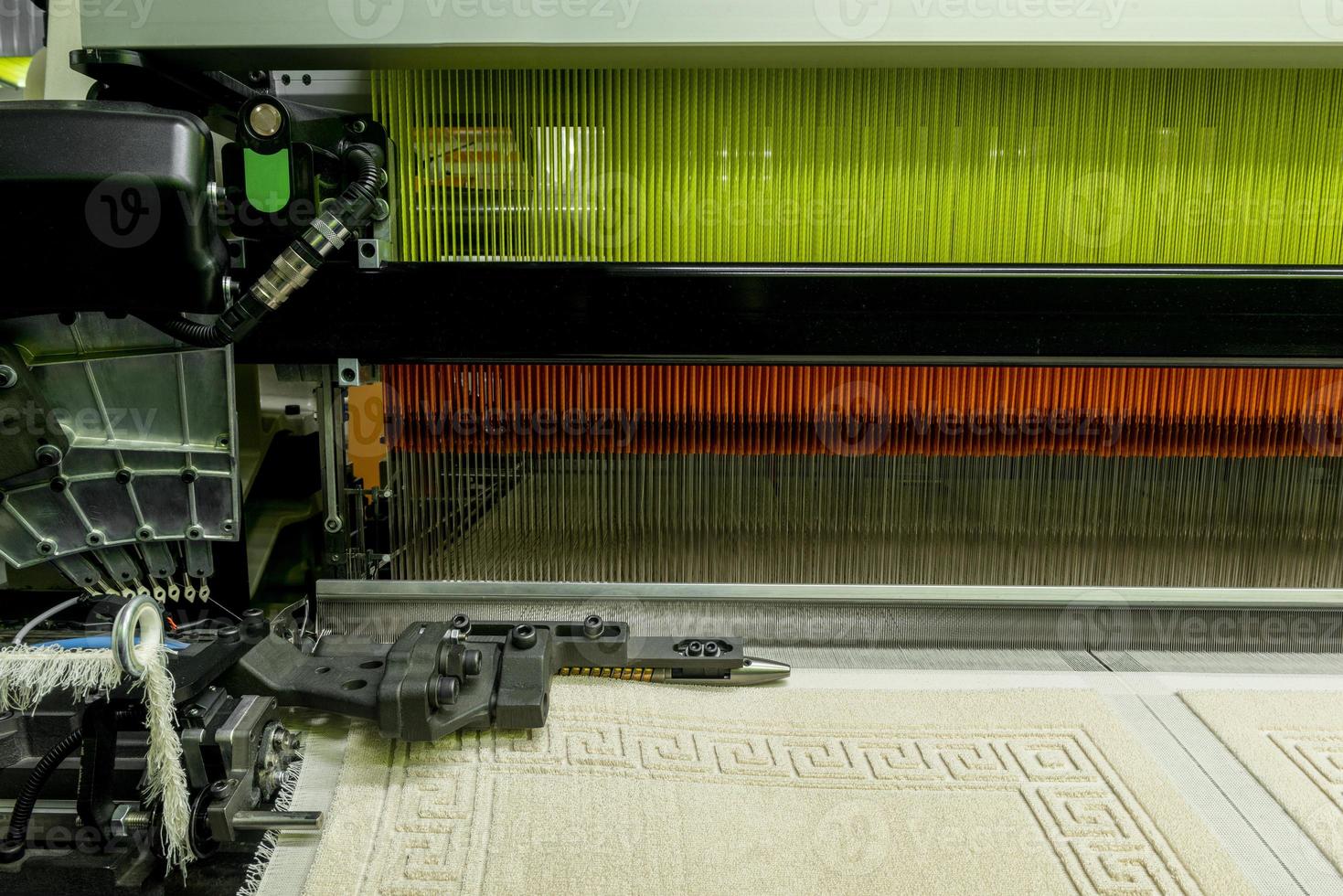 weaving loom at a textile factory, closeup. industrial fabric production line photo