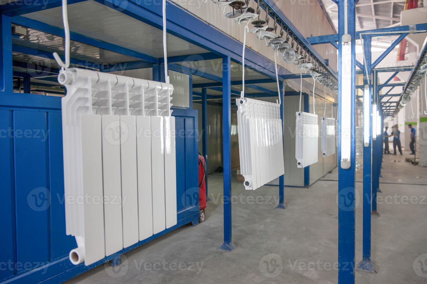 workshop for assembling and painting household heating radiators. conveyor line painting and drying of household heating radiators photo