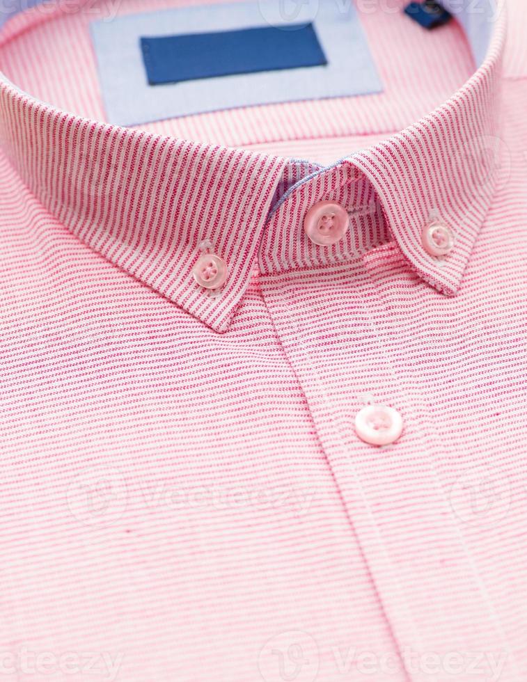 cotton shirt with a focus on the collar and button, closeup photo