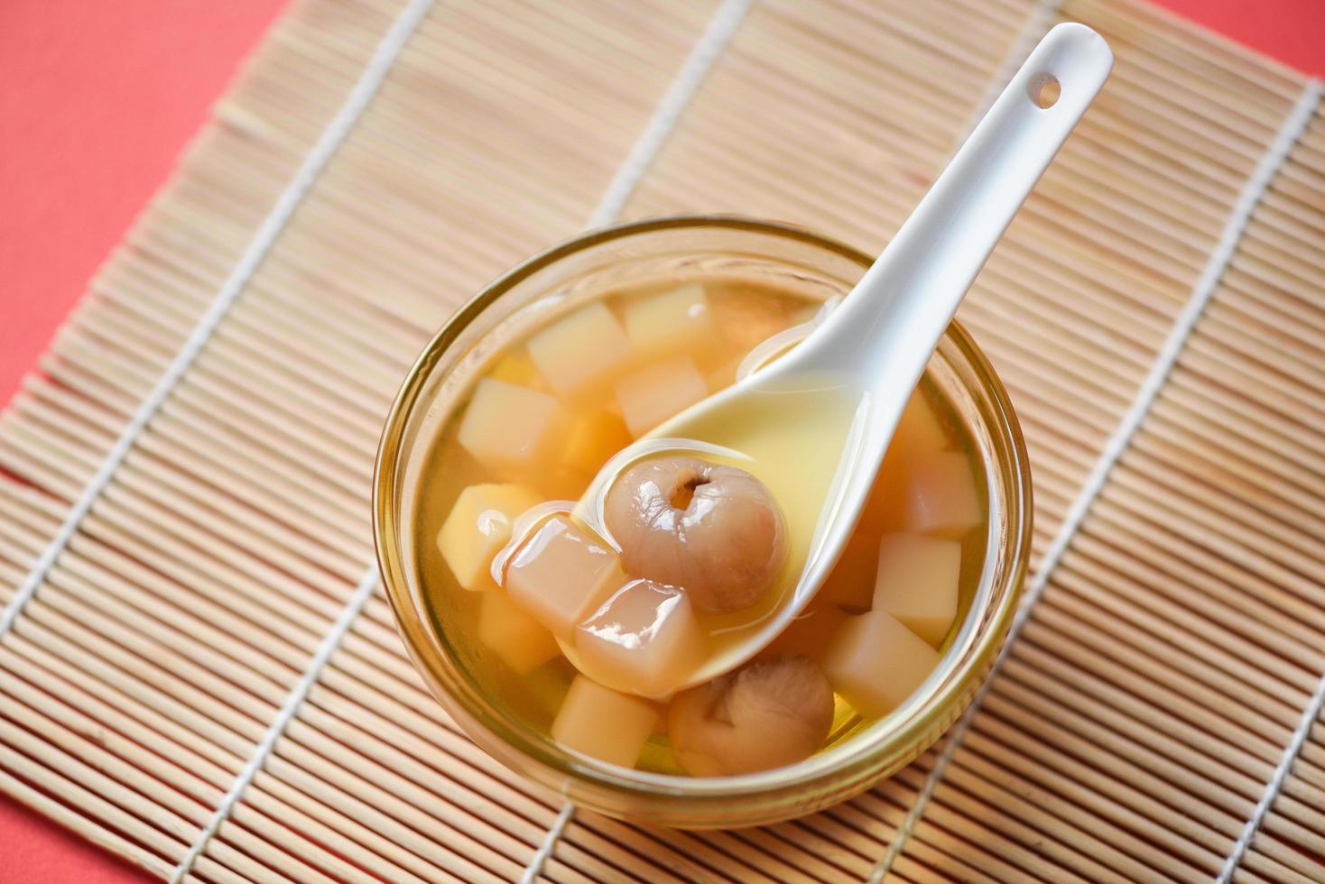 Chinese desserts, Mix ginkgo nuts cassava syrup coconut jelly in longan juice on glass bowl, Thai and Chinese longan date soup Asian dessert sweets photo