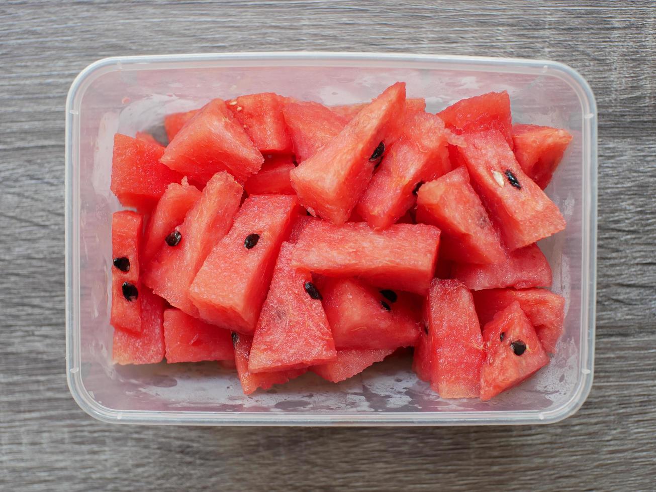 sliced fresh watermelon in a transparent container. healthy food and diet concept photo