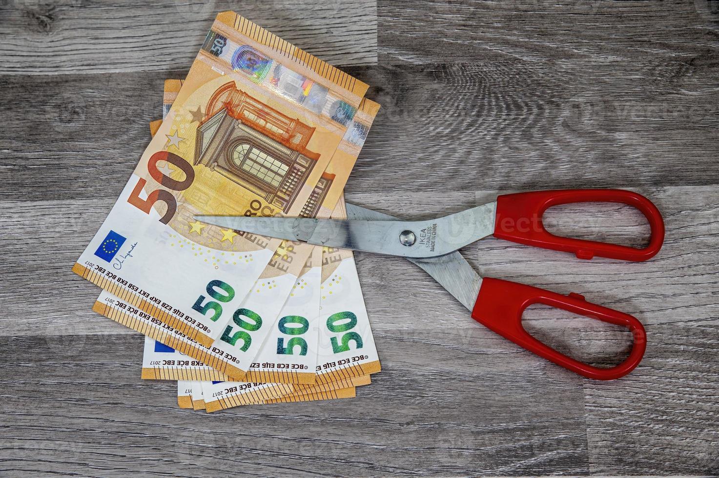 cut 50 banknotes with euro scissors photo
