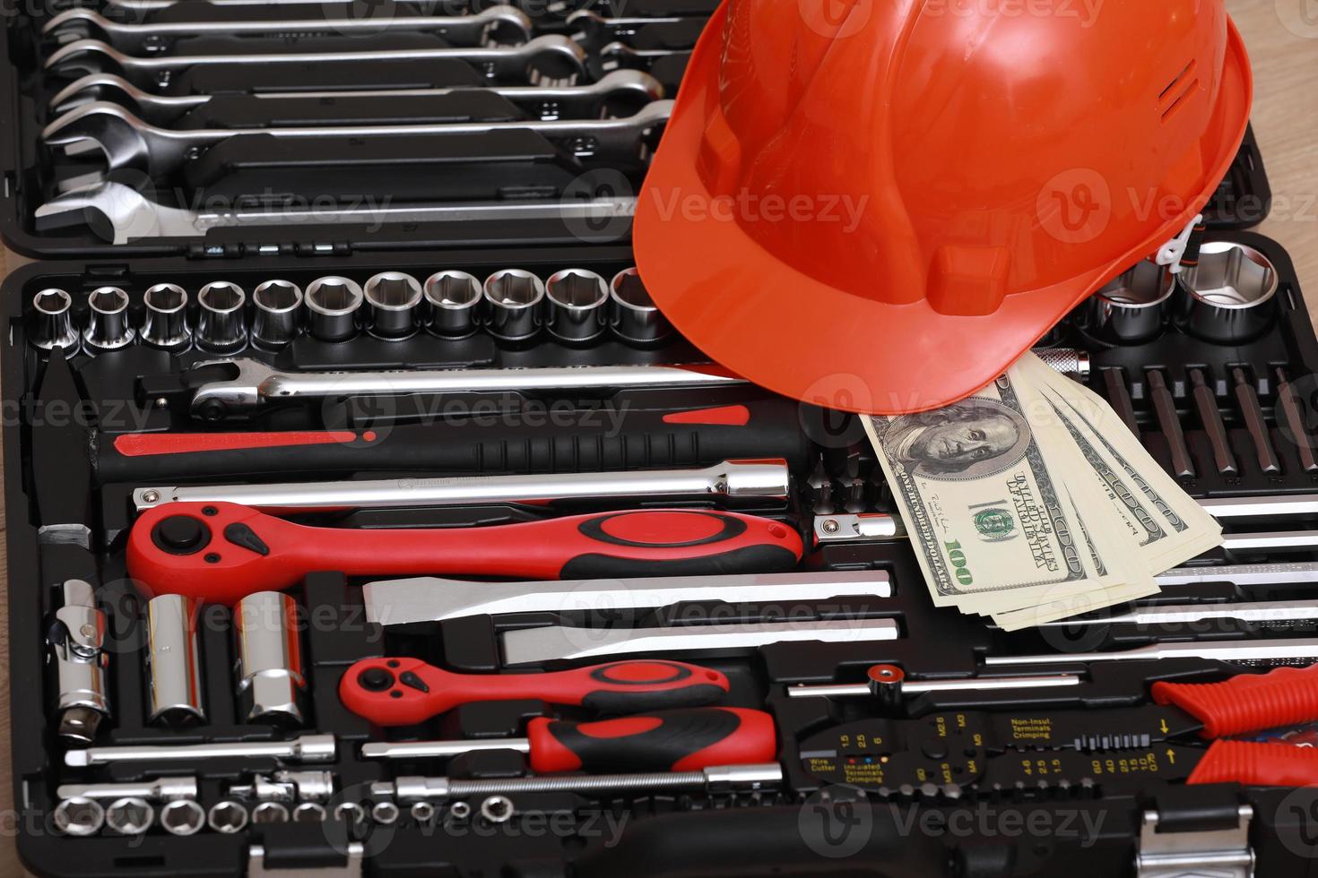 Toolbox, tools kit detail, dollar bills and orange protective helmet close up. instruments. set of tools. car tool kit. tool set background. instruments for repair. money for repairs photo