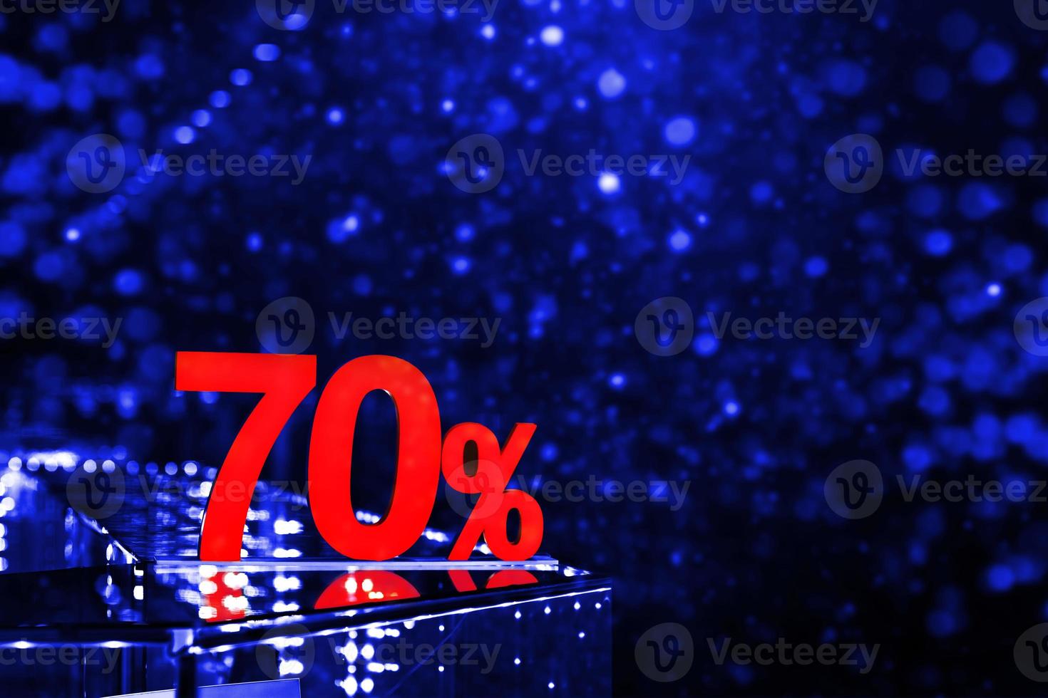 70 percent discount with blue bokeh background. Discounts in the shopping center. Seasonal sale, black friday. Red label. photo