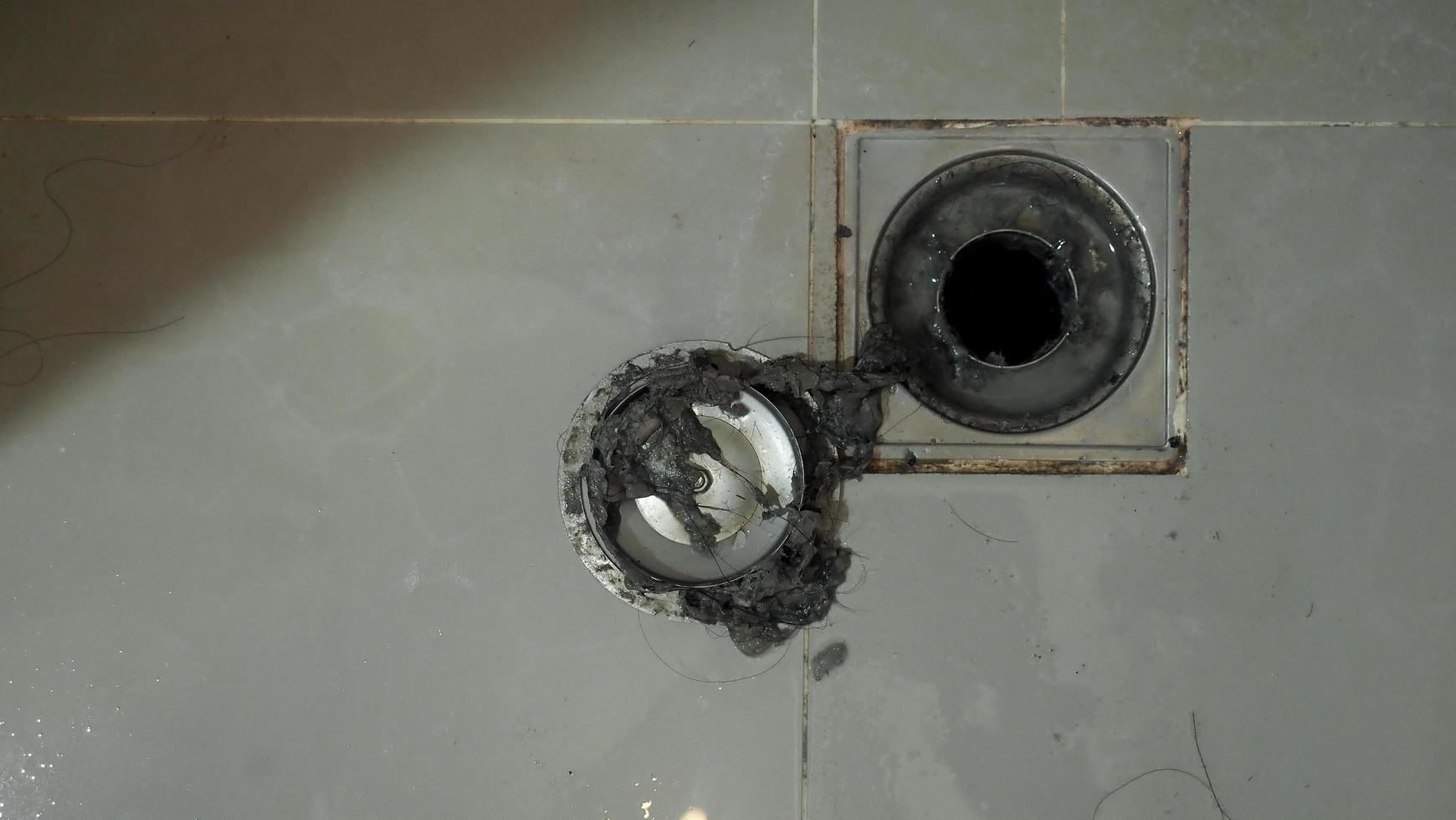 Drain cleaning. Clogged and dirty sewer pipes floor drain. photo