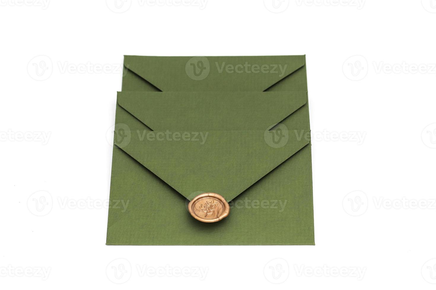 green envelope with designer cardboard and seal on a white background. Envelope with seal photo