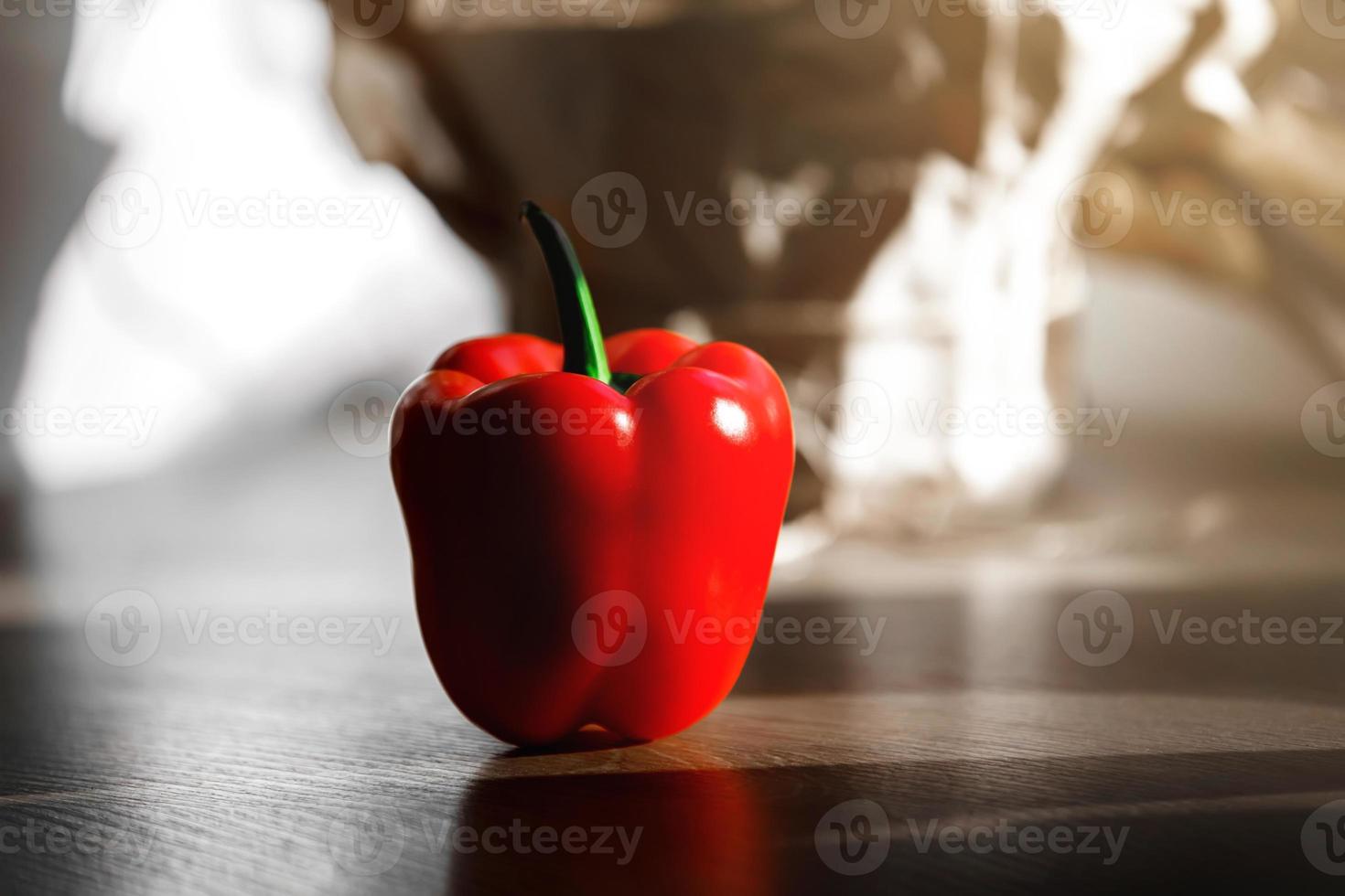 fresh red pepper on a table with sun light from kitchen window photo