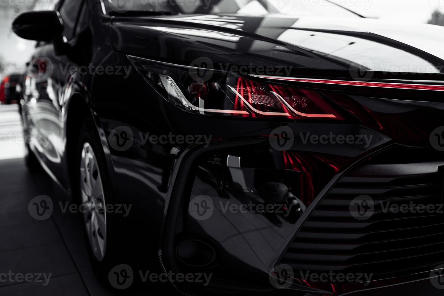 headlight of modern prestigious black car close up. Close up photo of modern car, detail of headlight. Headlight car Projector LED of a modern luxury technology and auto detail. selective focus