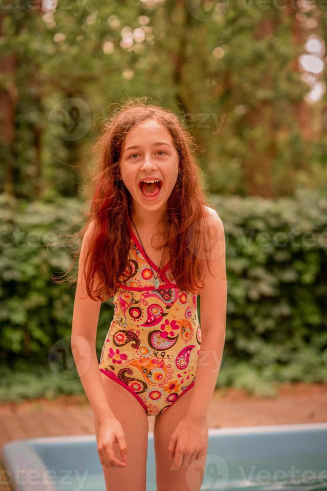 The girl and the pool. A teenager in a positive mood laughs on vacation ...