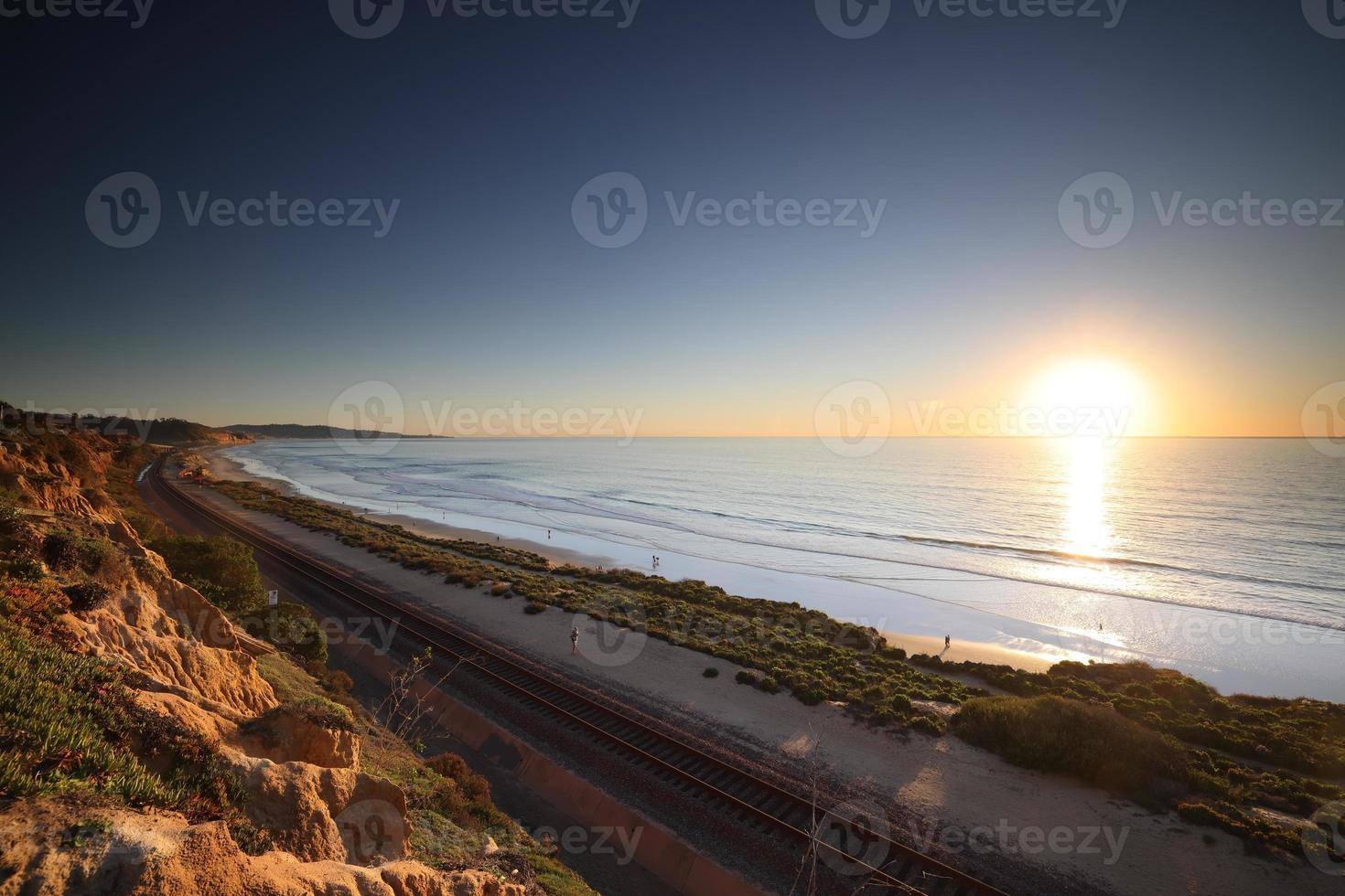 Amtrak trains along the San Diego coastline at dusk photo