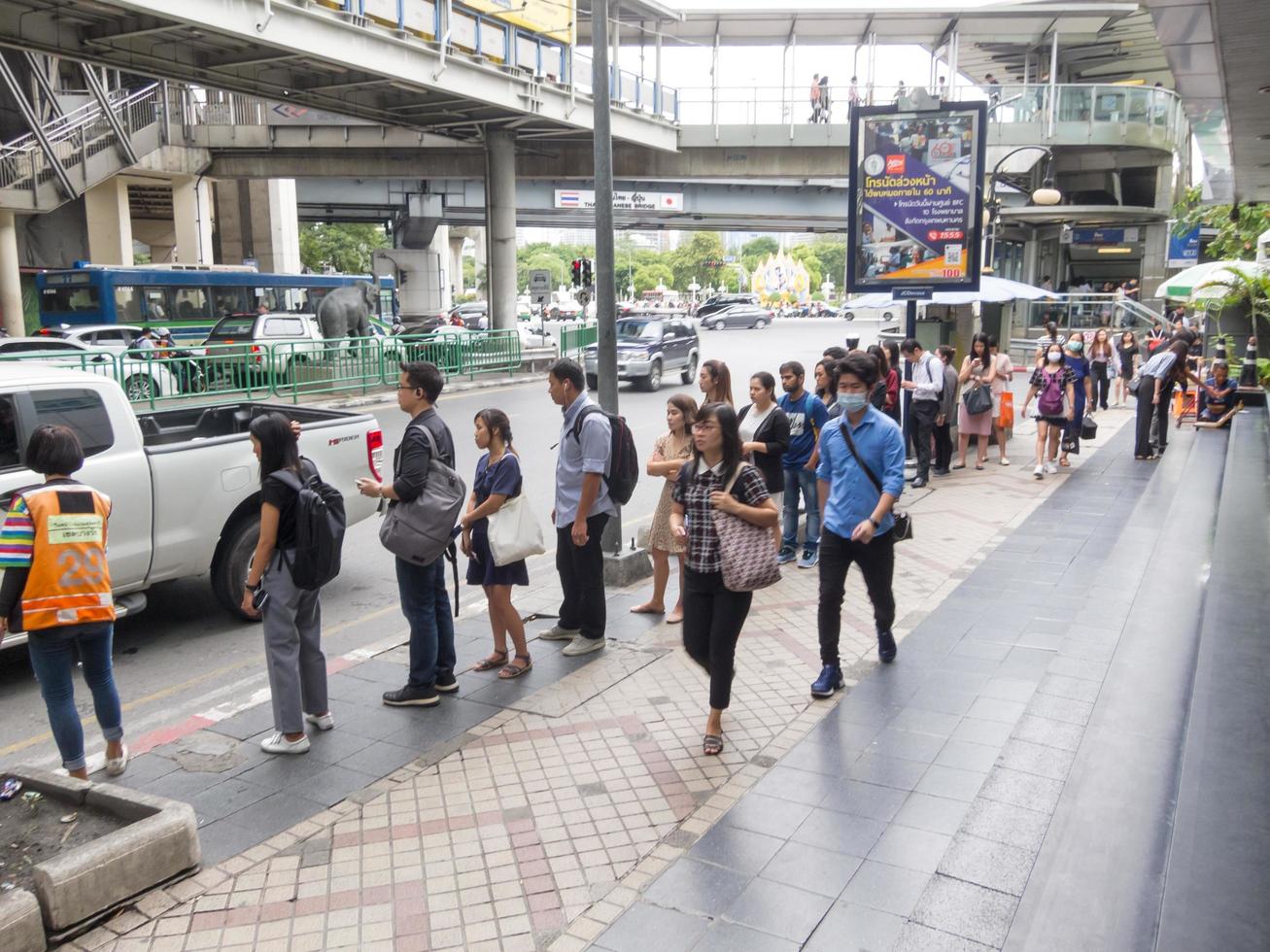 Silom BANGKOKTHAILAND16 AUGUST 2018  In the morning people are walking to work and doing activities such as buying coffee to buy or shopping for lottery tickets and queuing for a motorcycle. photo