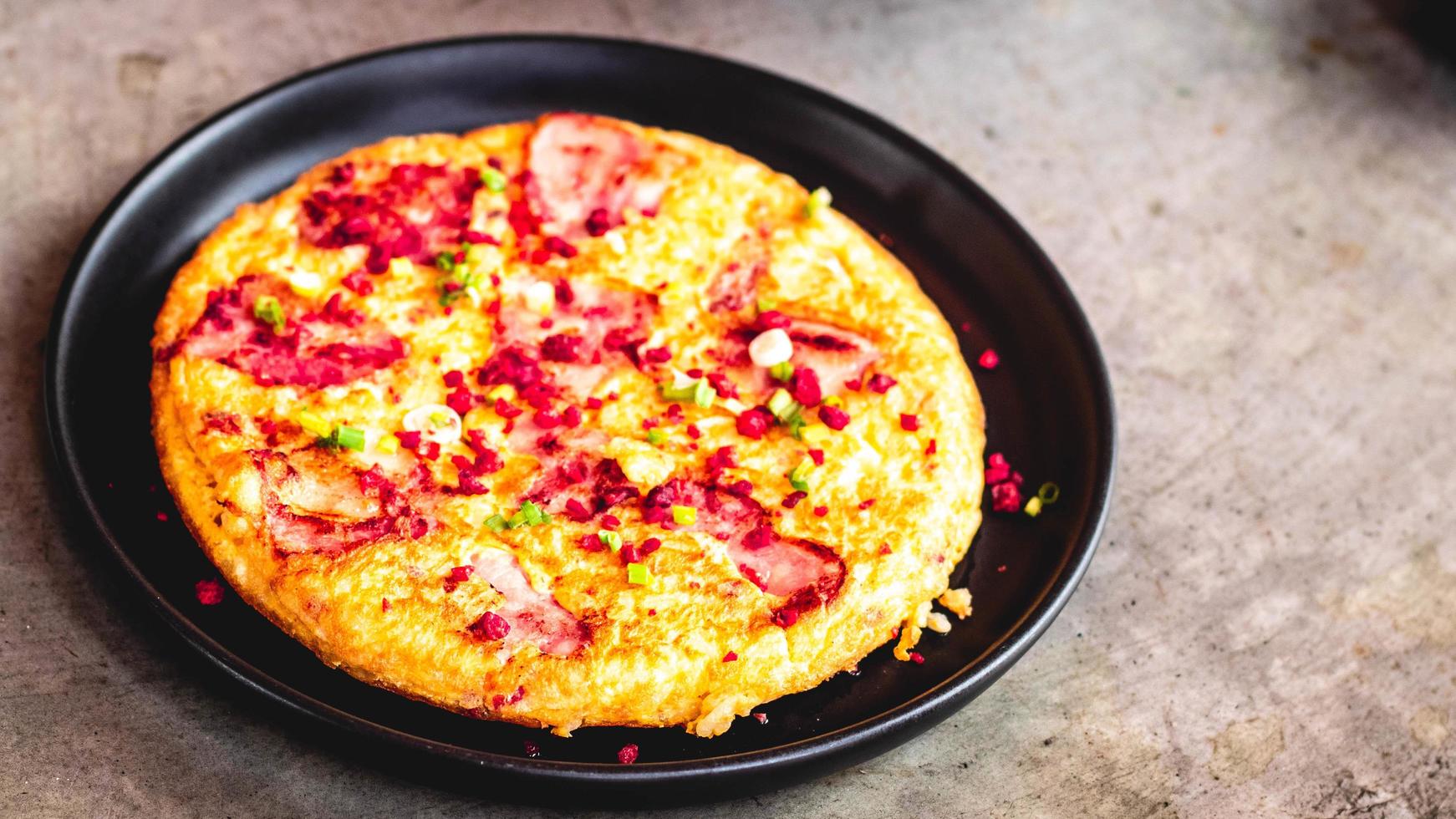 Spanish omelet Frittata made of eggs potato bacon paprika parsley green peas onion cheese for delicious food. photo