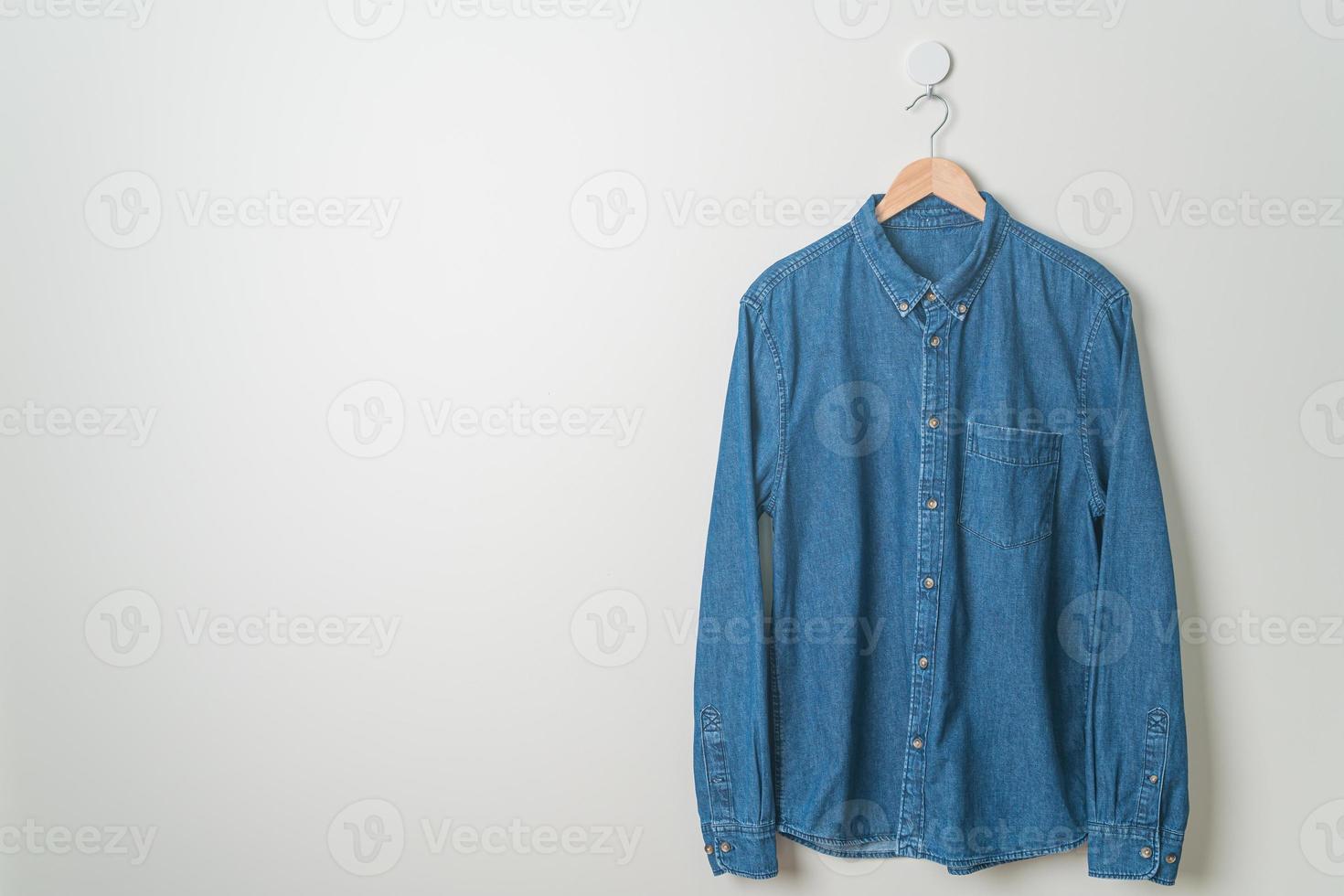 hanging shirt with wood hanger on wall photo