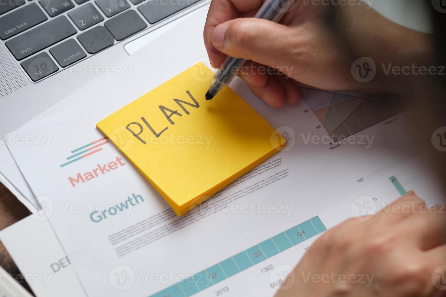 asian woman holding paperwork flow of project checking with laptop data working at home photo