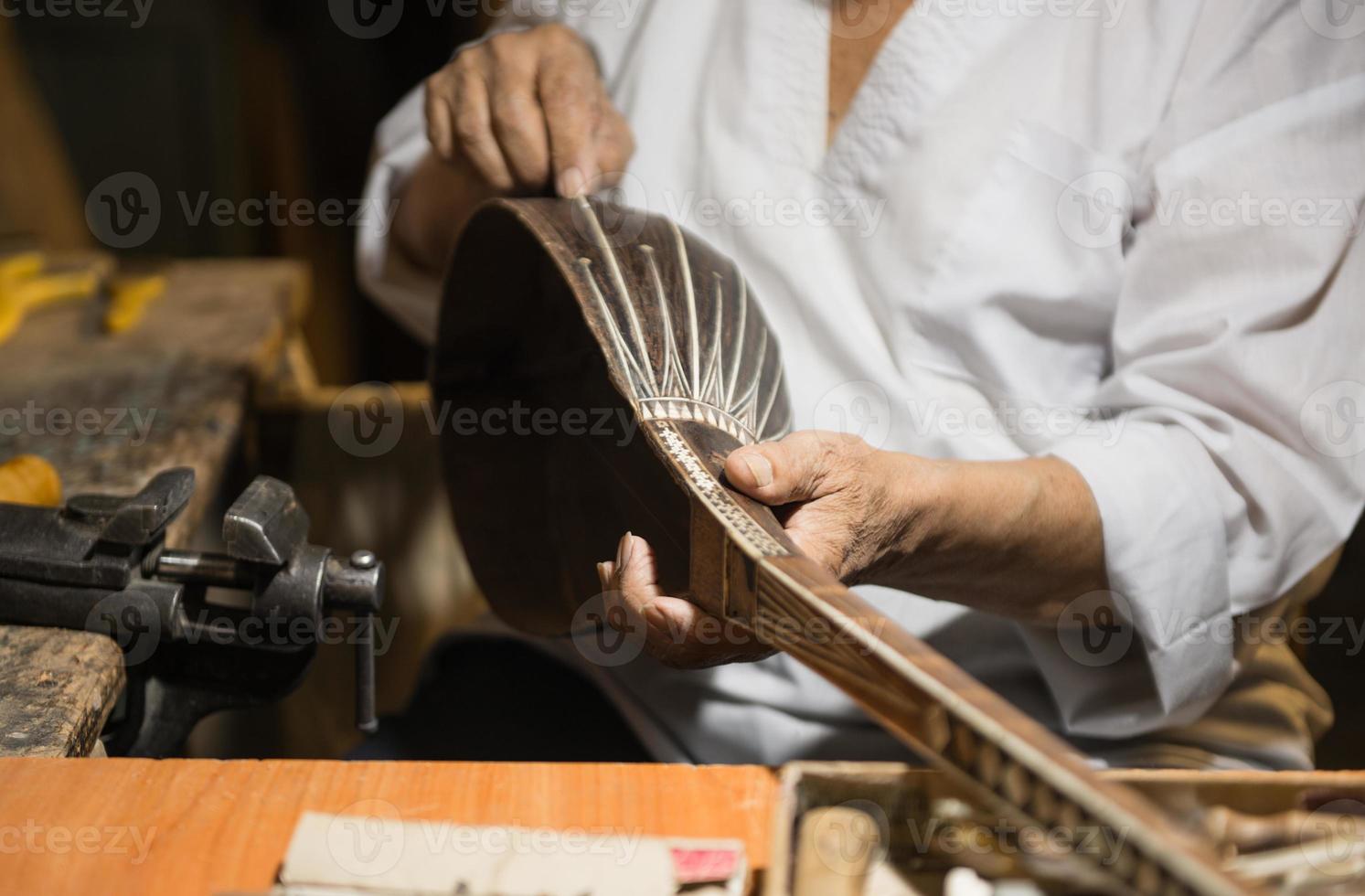 adult master restores old musical instruments. production of stringed instruments photo