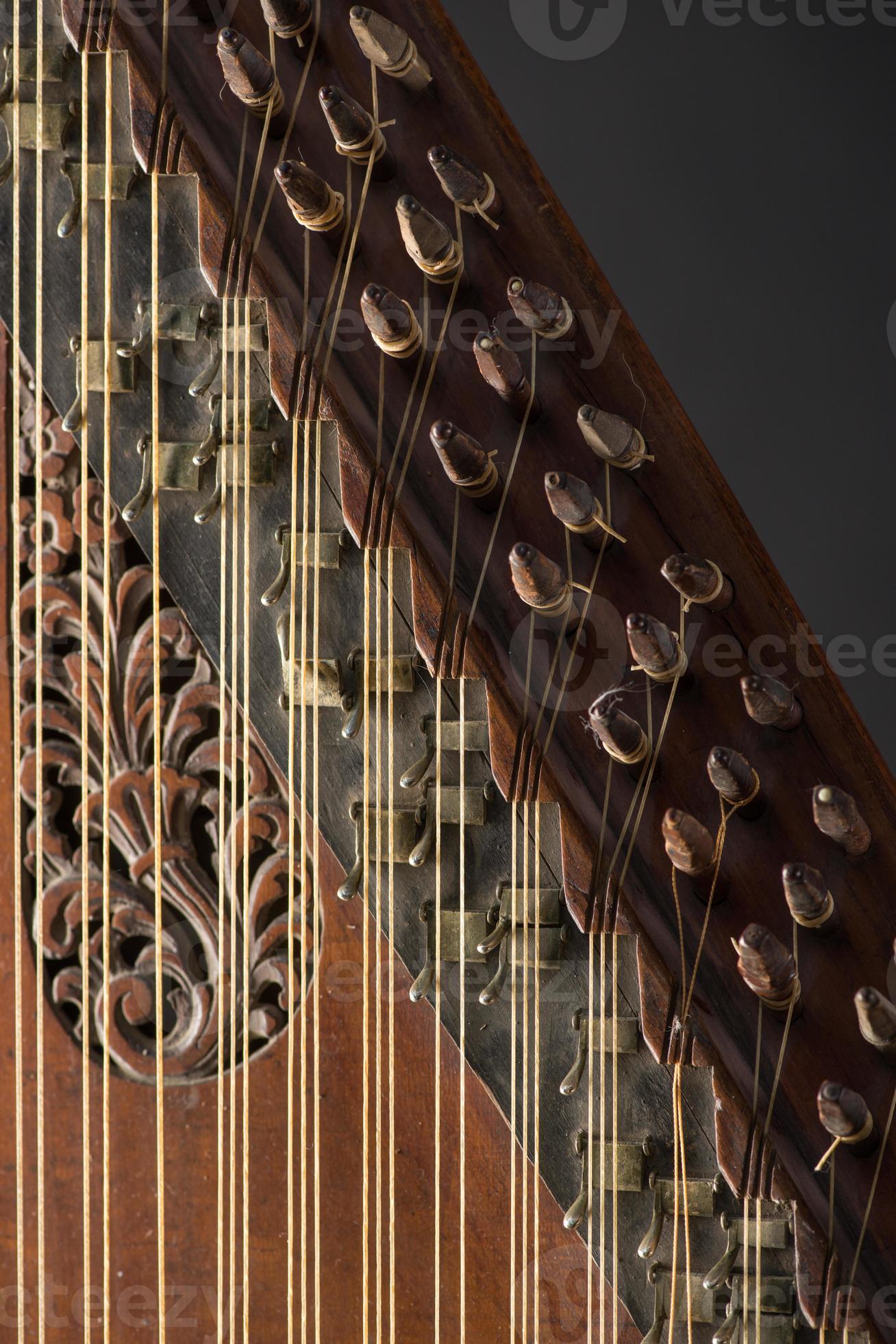 ancient Asian stringed musical instrument on black background with  backlight. the similarity of the harp and psaltery. closeup 5484959 Stock  Photo at Vecteezy