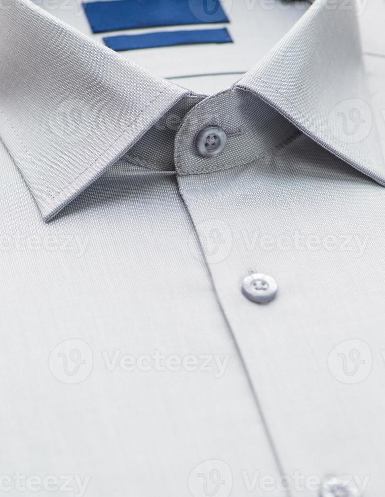 cotton shirt with a focus on the collar and button, closeup photo