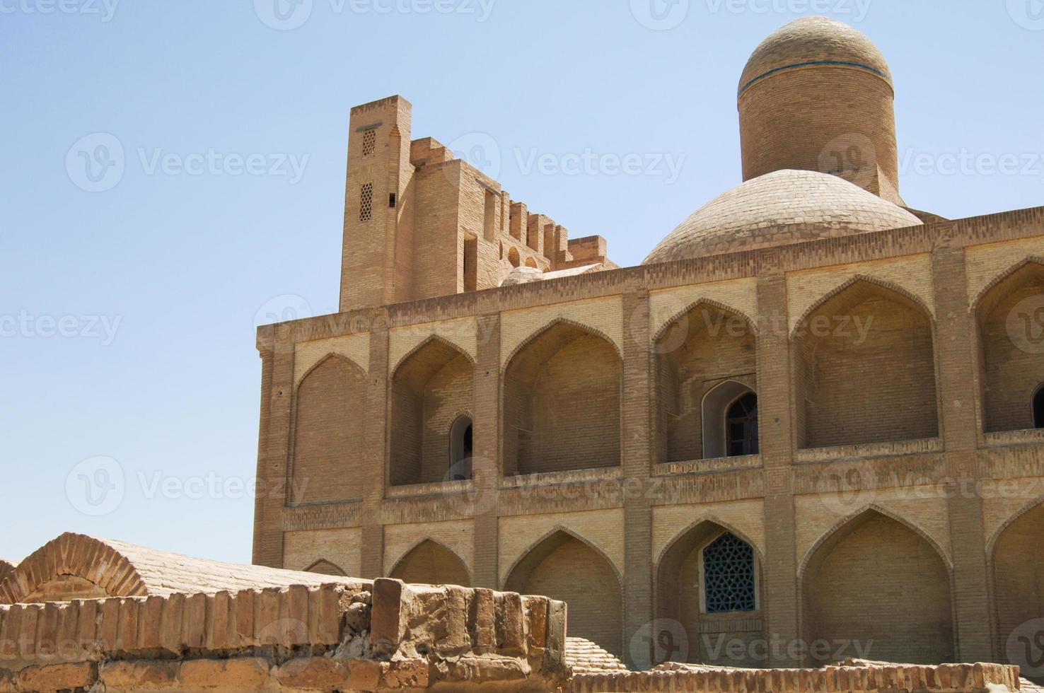 Old multi storey building with dome, subject to restoration. the ancient buildings of medieval Asia photo