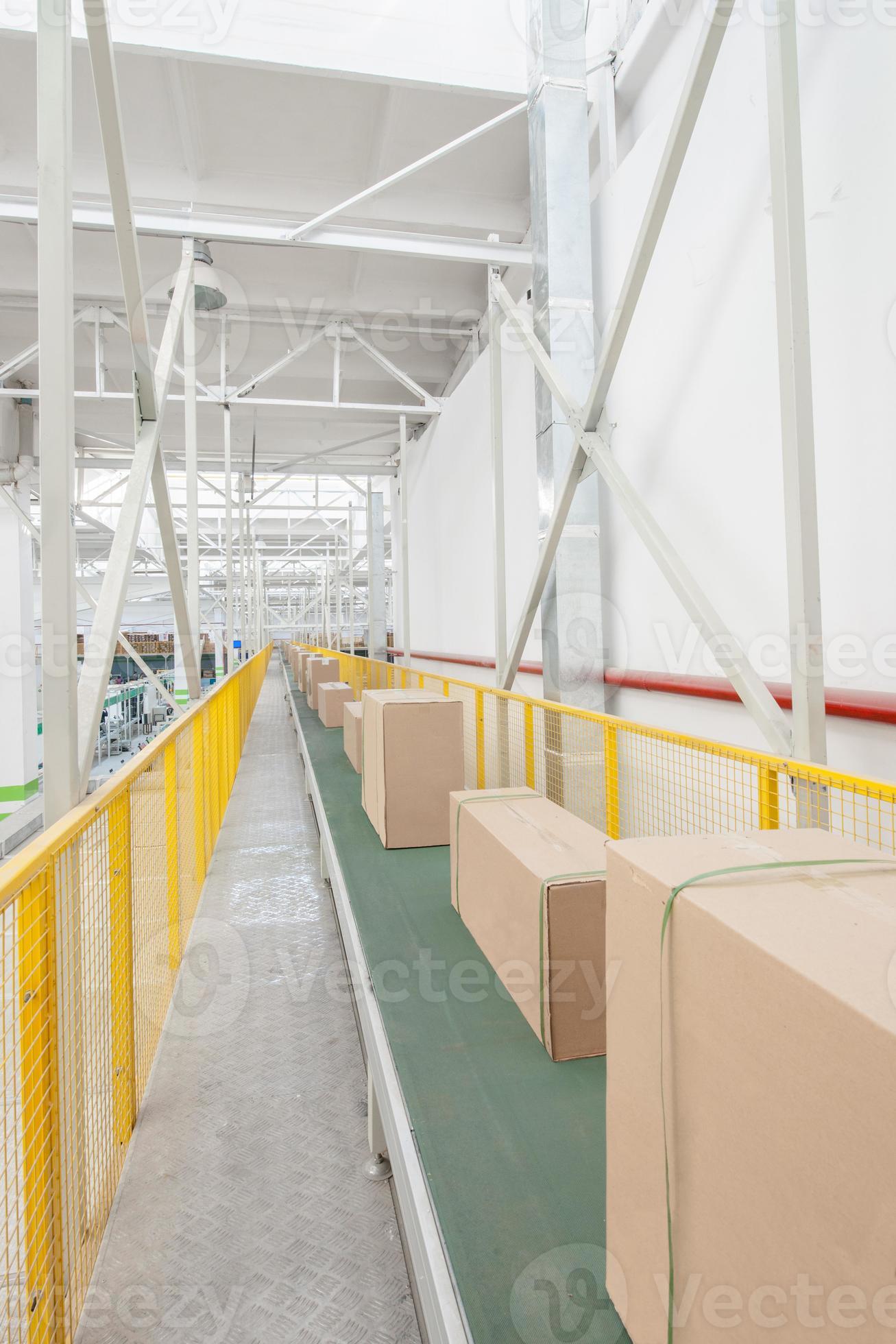 packed electrical engineering cardboard boxes on a conveyor belt in